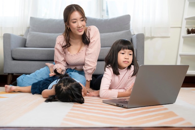 Asian family with children using laptop computer at home