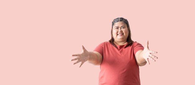 Asian fat woman Fat girl Chubby showing hand blank area for sign isolated on pink background Clipping paths for design work empty free space