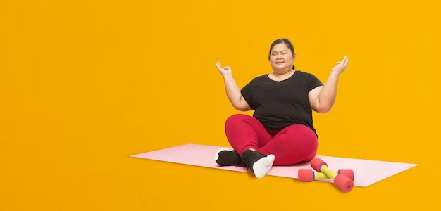 Asian fat woman workout isolated on yellow background Clipping paths for design work empty free space