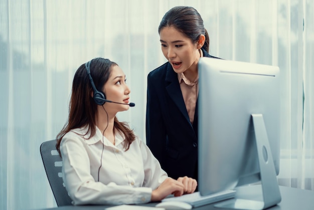 Asian female customer support operator guided by manger Enthusiastic