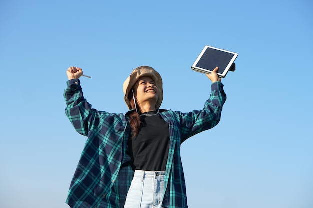 Asian female farmer delighted with rice growth target Computer analysis