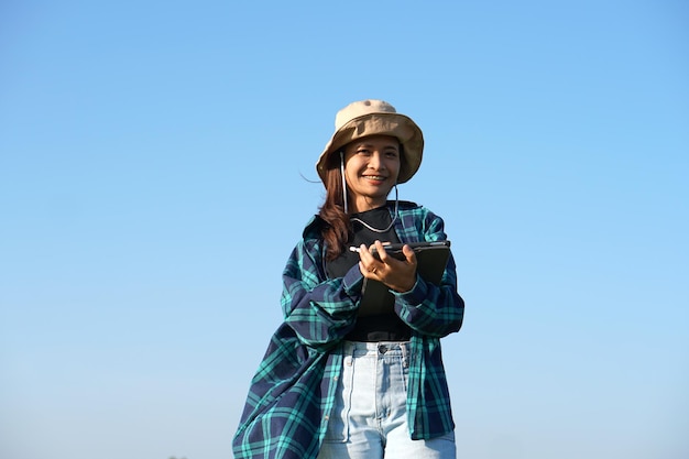 Asian female farmers use computers to analyze the growth of rice plants