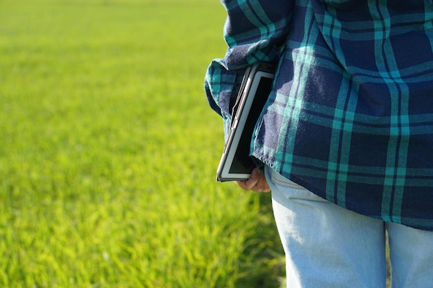 Asian female farmers use computers to analyze the growth of rice plants