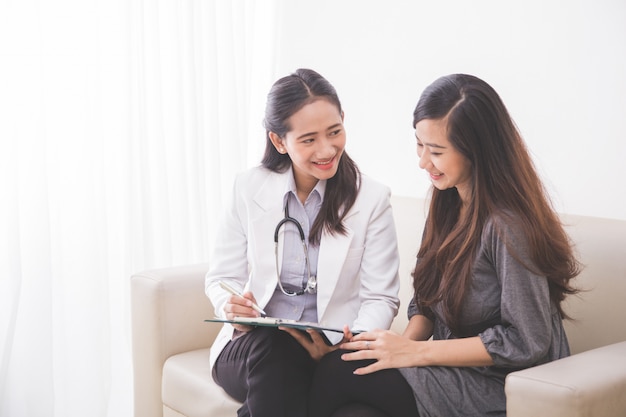 Asian female patient consulting with a female doctor