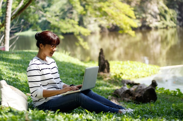 Asian female student doing the homework with diligence while sitting in the university.