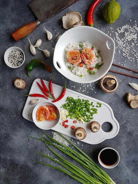 Asian food on a dark background, Wok rice with shrimps and mushrooms, During preparation, Vertical, Top view, Flatlay