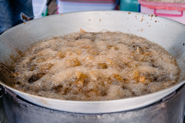 Asian Fried Chicken are fried by palm oil in the large pan