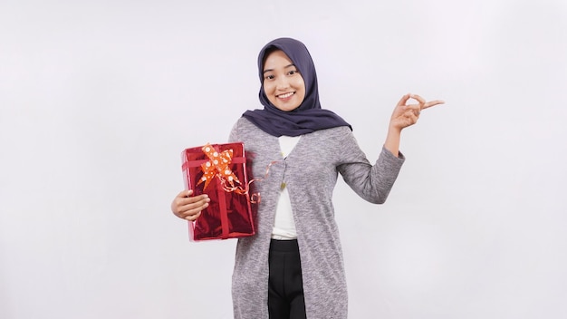 Asian girl carrying a gift showing side blank isolated on white background