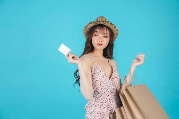 Asian girl carrying shopping bags and enjoys shopping