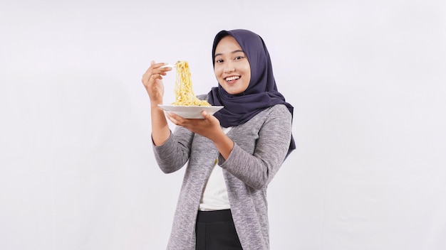 Asian girl happily enjoying noodles isolated on white background