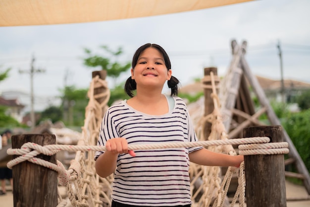 Asian Girl playing on playground happy little Asia girl child having fun to playing in the playground