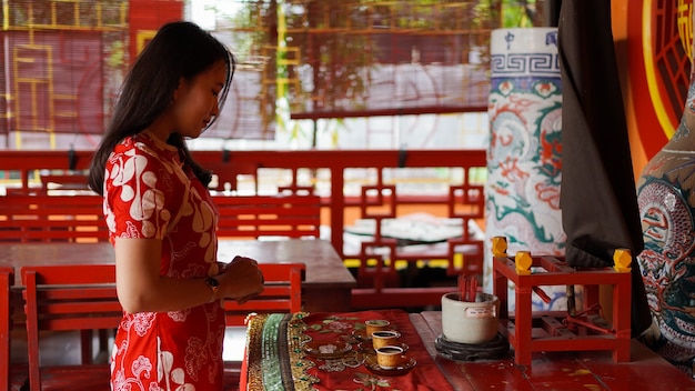 Asian girl praying and wishing a happy chinese new year at vihara