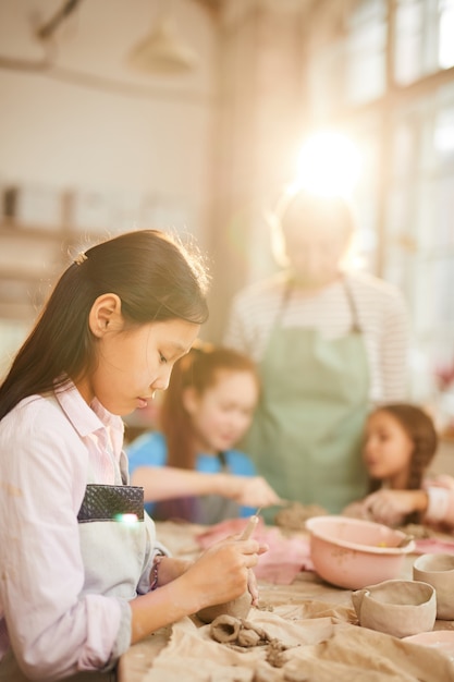 Asian Girl Shaping Clay