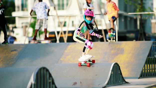 asian girl sufe skate or skateboarding on skate park