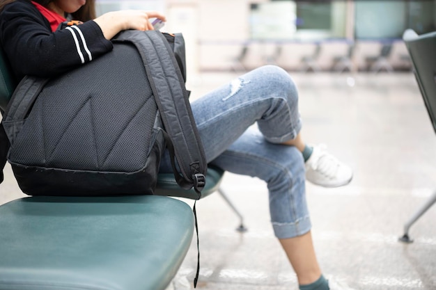 Asian girl waiting for departure at the airport on your vacation