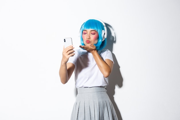 Asian girl wearing a blue wig posing