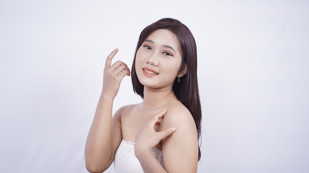 Asian girl wearing makeup showing her smiling face isolated on white background