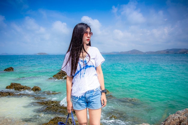 Asian girl with sea viewPortrait of a happy Asian girl at the beach Nice vacation in summerPhuket