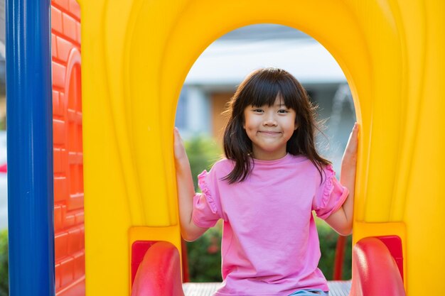 Asian girls playing slides play ground