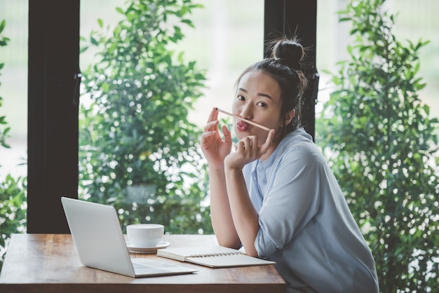 Asian girls sitting working comfortably at home.