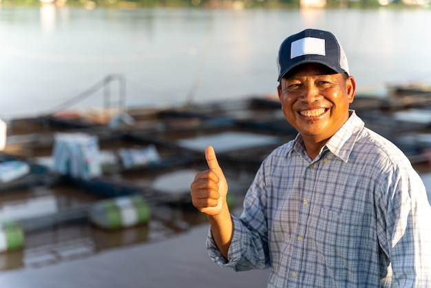 Asian happy aquaculture farmers at ponds and cages Tilapia Farming Tilapia fish