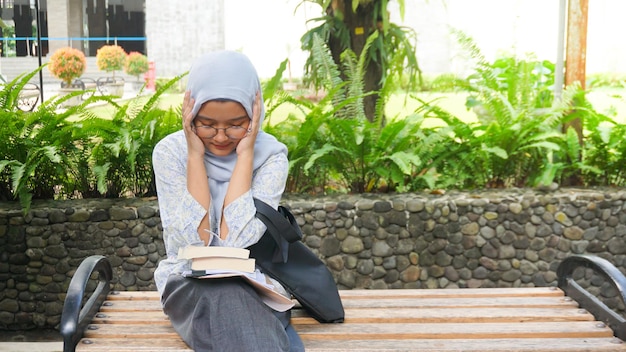 Asian hijab girl is dizzy because she is taking an exam