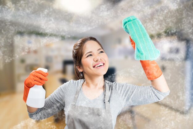 Asian housewife cleaning glass