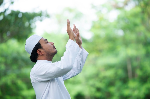 Asian islam man prayerYoung Muslim prayingRamadan festival concept