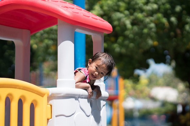 Asian kid playing in the playground