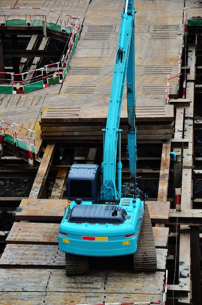 Asian labor people and thai labour workers use machine and heavy machinery working builder new structure tower highrise building on scaffold at construction site at capital city in Bangkok Thailand