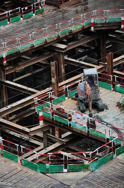 Asian labor people and thai labour workers use machine and heavy machinery working builder new structure tower highrise building on scaffold at construction site at capital city in Bangkok Thailand