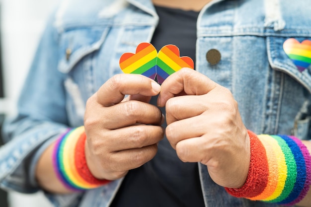 Asian lady wearing rainbow flag wristbands symbol of LGBT pride month celebrate annual in June social of gay lesbian bisexual transgender human rights