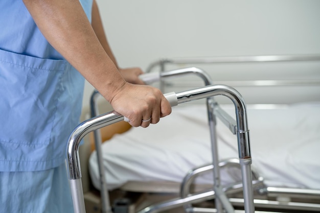 Asian lady woman patient walk with walker at nursing hospital ward healthy strong medical concept