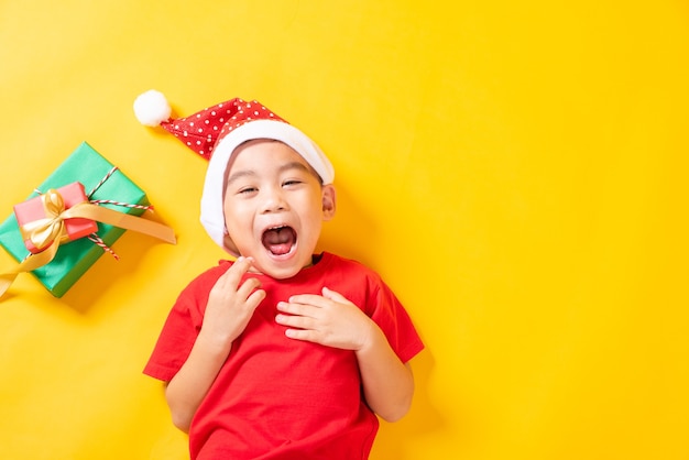 Asian little boy smile in red Santa Claus hat