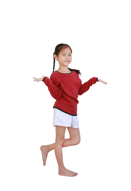 Asian little child gesture hands to present with Stand on one leg on white isolated background with clipping path