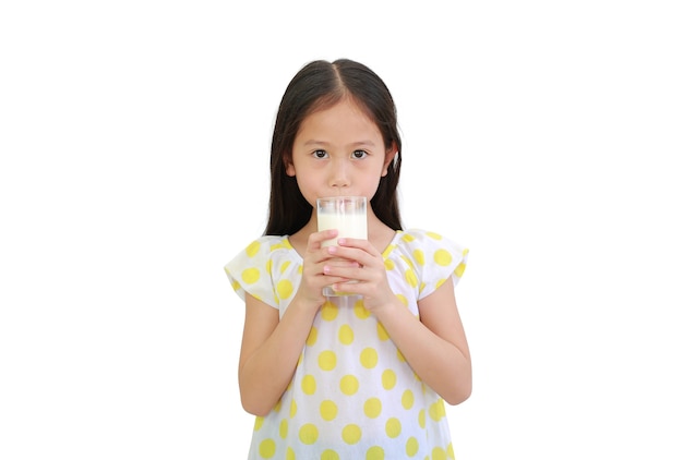 Asian little child girl drinking milk from glass