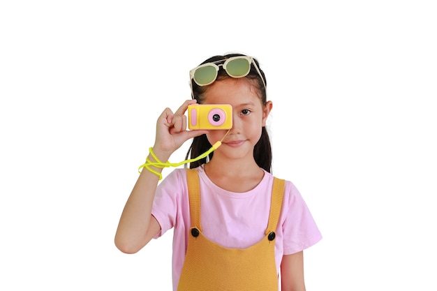 Asian little girl child taking picture with photo camera isolated on white background