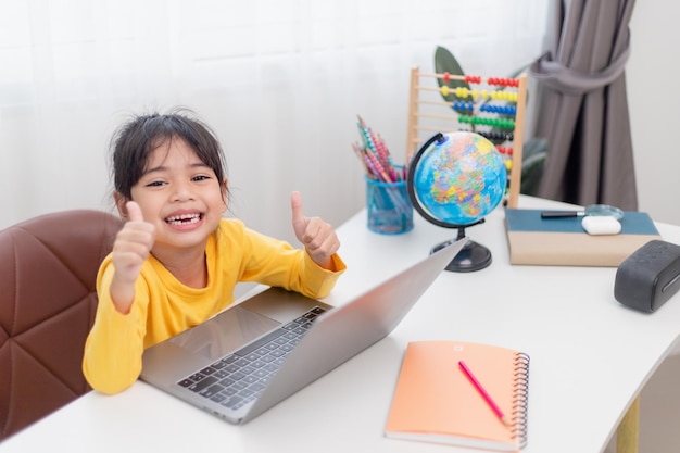 Asian little girl at home doing homework