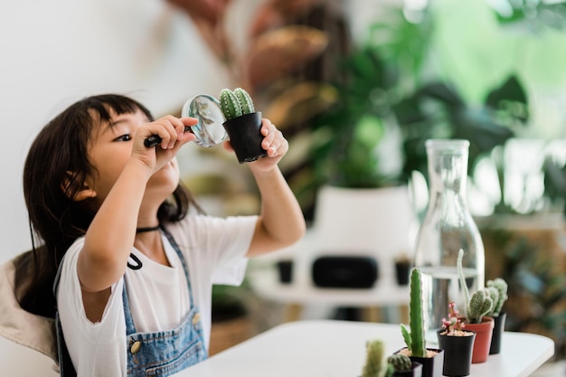 Asian little girl is planting plants in the house concept of plant growing learning activity for a preschool kid and child education for the tree in nature