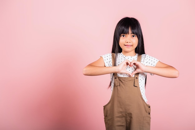 Asian little kid 10 years old showing heart sign