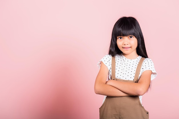 Asian little kid 10 years old smiling with arms crossed