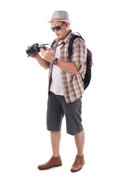 Asian male backpacker photographer tourist Taking Pictures with his mirrorrless