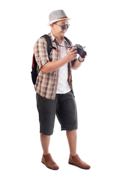 Asian male backpacker photographer tourist Taking Pictures with his mirrorrless