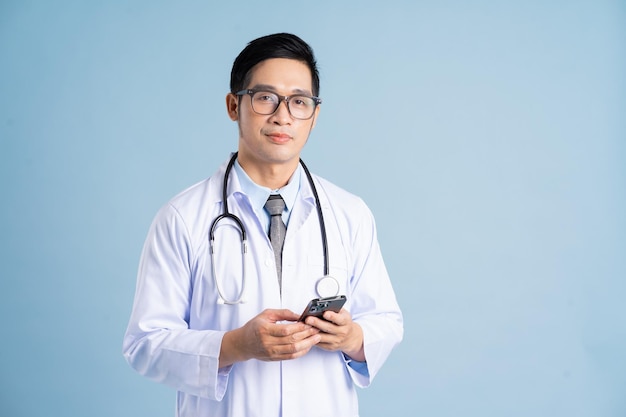 Asian male doctor portrait on blue background