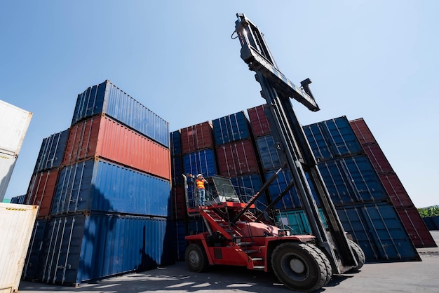 Asian male engineer using radio communication working at the warehouse container