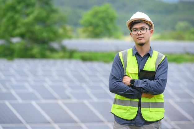 Asian male engineer Work with solar panels and install solar panels at photovoltaic power stations working on industrial solar energy storage