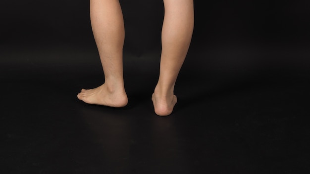 Asian Male legs calf and barefoot is isolated on black background