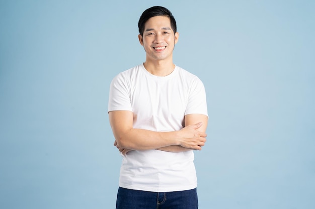 Asian male portrait posing on blue background