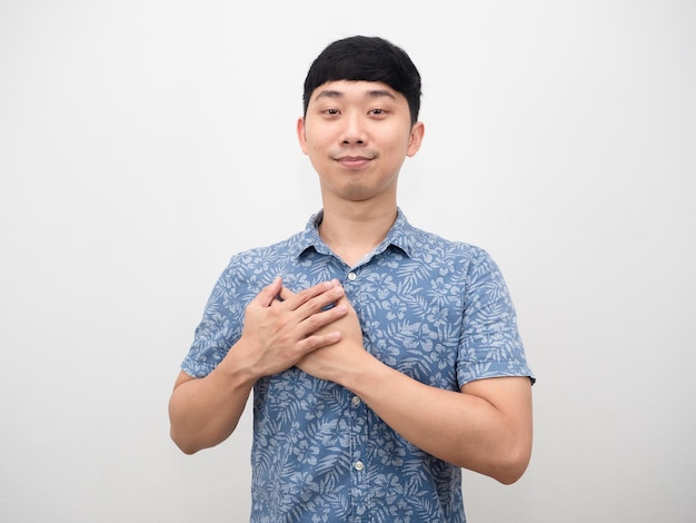 Asian man blue shirt cheerful and touch his chest feeling hopeful