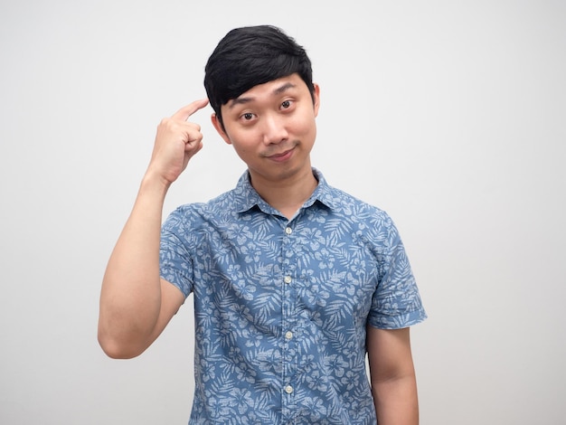 Asian man blue shirt point finger at his head for thinking